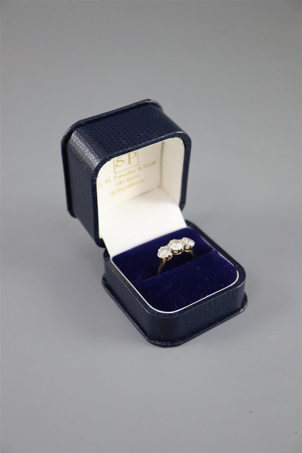 A modern 18ct gold and three stone brilliant cut diamond ring,